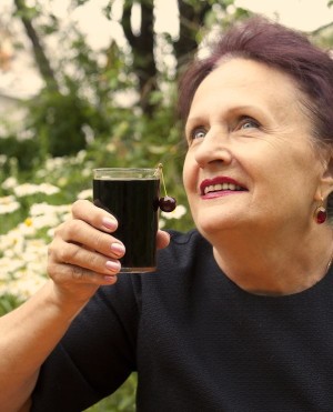 Woman drinking cherry juice